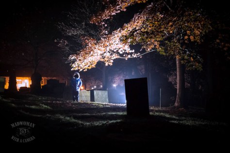 Faceless boy at halloween in graveyard